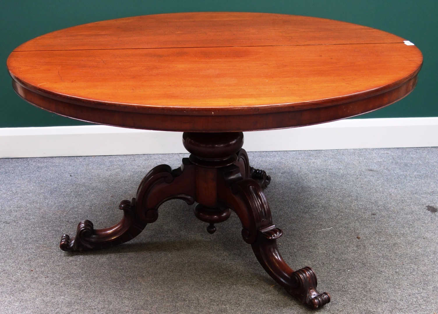 Appraisal: A Victorian mahogany circular snap top breakfast table on turned