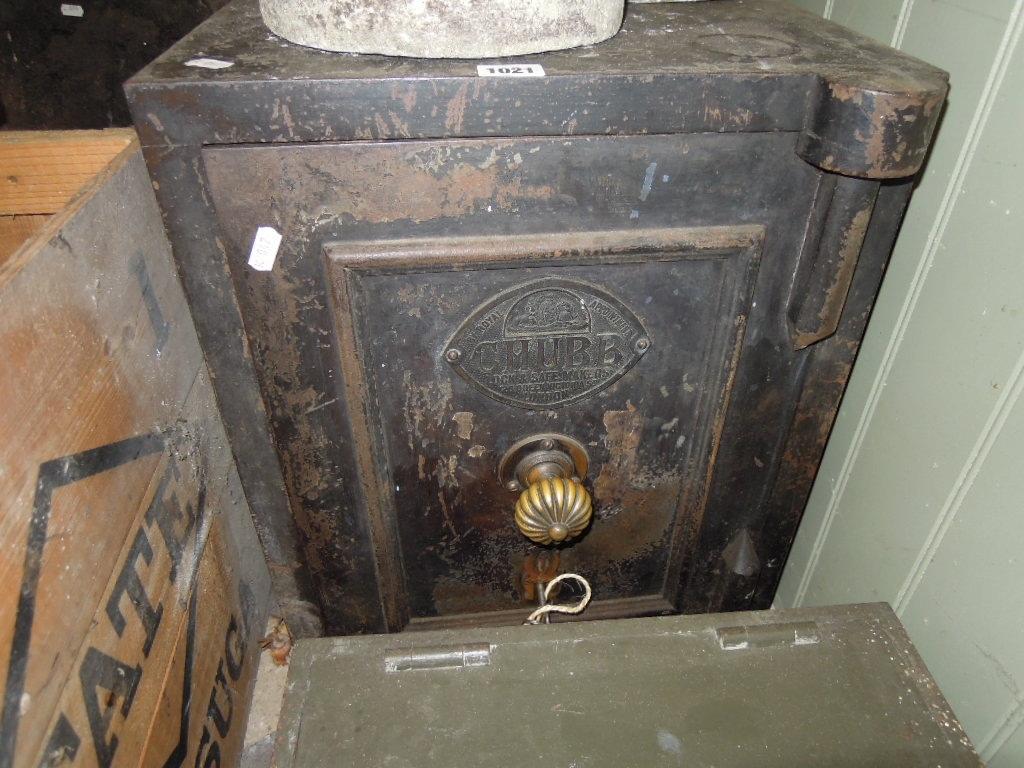 Appraisal: A Chubb cast iron safe enclosed by a single panelled