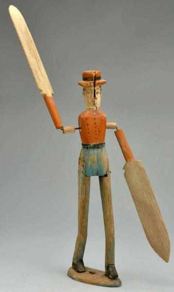 Appraisal: Wooden Primitive Whirligig Operational Arms are depicted as oars One