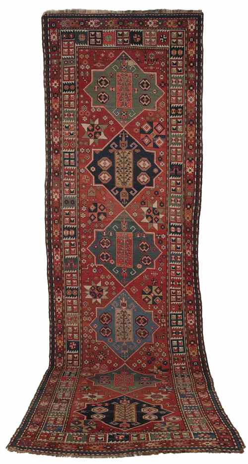 Appraisal: Caucasian runner with six medallions on a red rust field