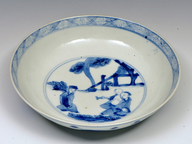 Appraisal: A CHINESE BLUE AND WHITE SAUCER DISH decorated with kneeling