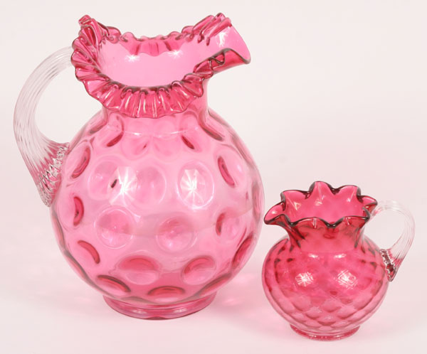 Appraisal: Cranberry glass pitchers coinspot pitcher with ruffled edge and clear