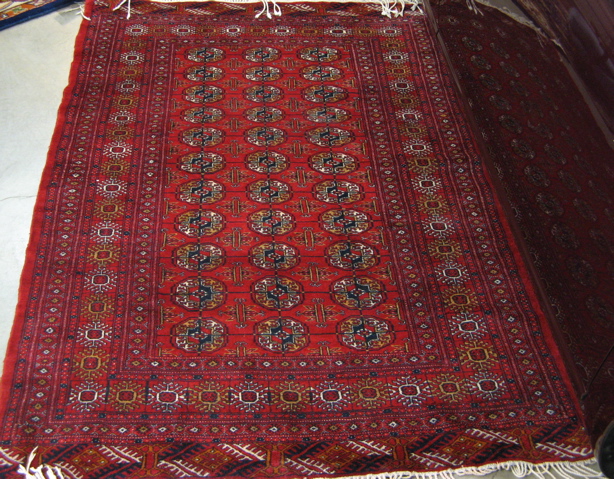 Appraisal: TWO PERSIAN TURKOMAN AREA RUGS both having three columns of