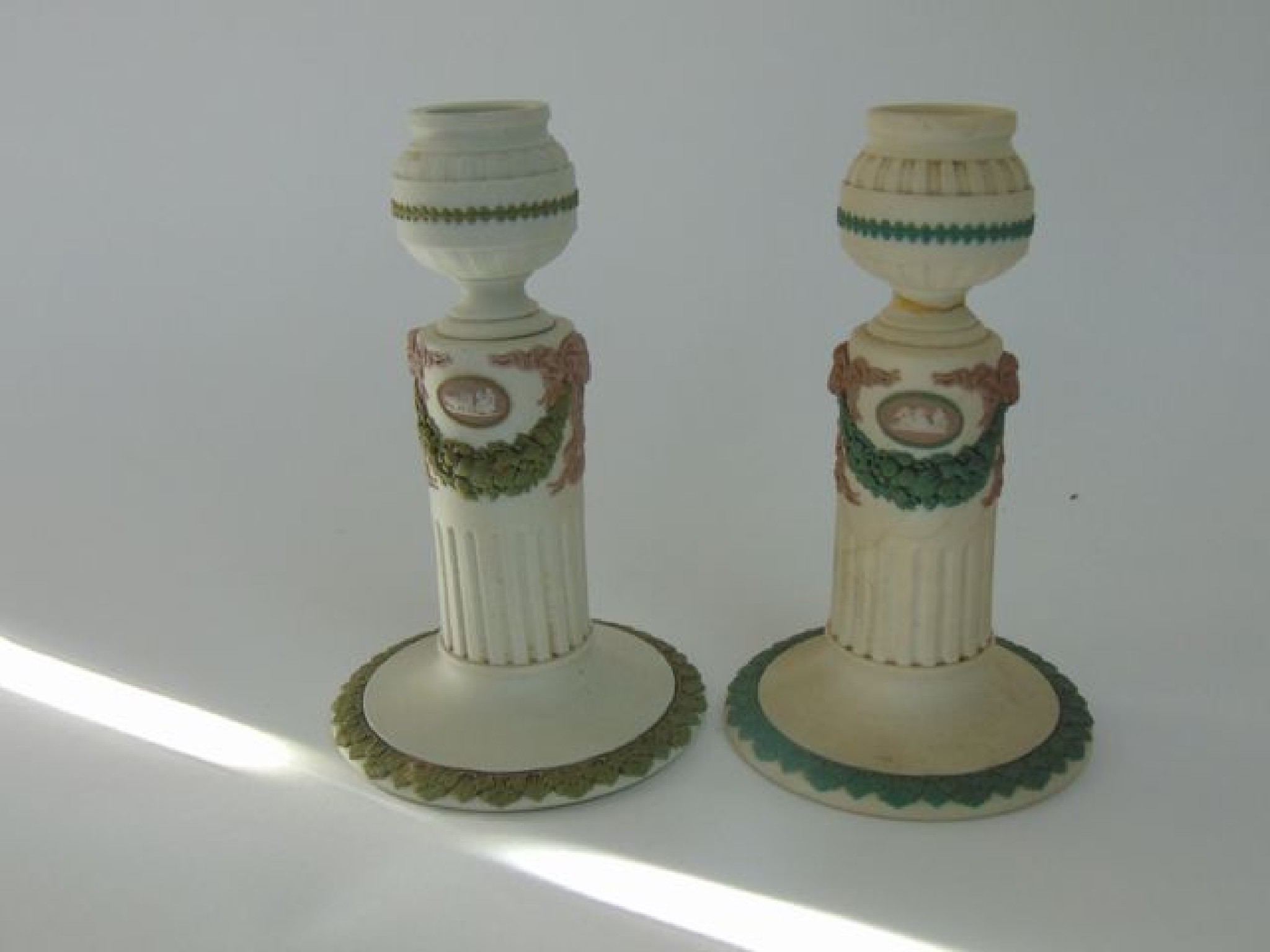 Appraisal: A matched pair of Wedgwood Tri-colour candlesticks in the classical