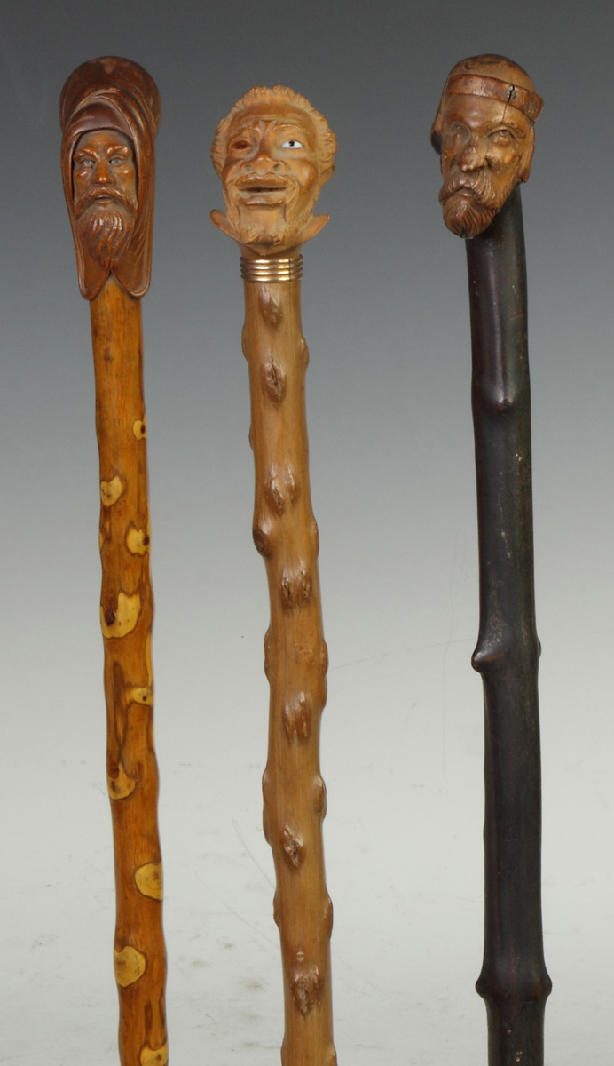 Appraisal: Three Carved Wood Canes w Faces L to R Middle