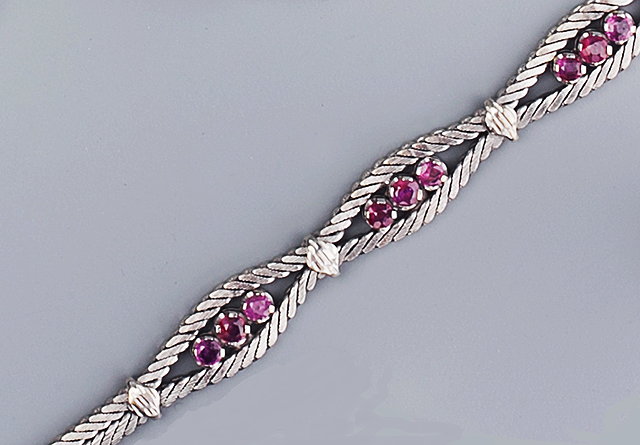 Appraisal: A RUBY SET BRACELET composed of herringbone links centred with