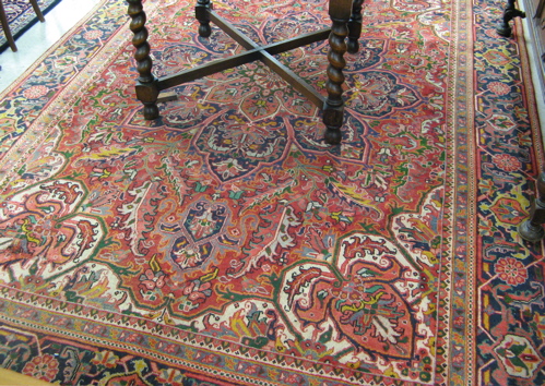 Appraisal: SEMI-ANTIQUE PERSIAN HERIZ CARPET centering a large florette medallion on