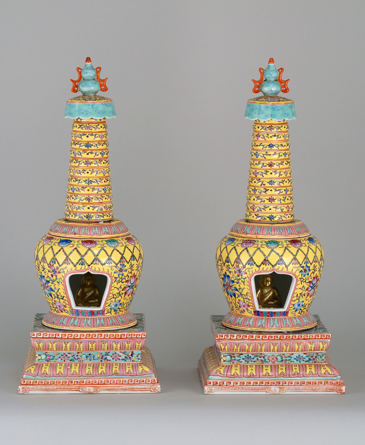 Appraisal: PAIR OF POLYCHROME PORCELAIN STUPAS th CenturyWith ovoid bodies resting