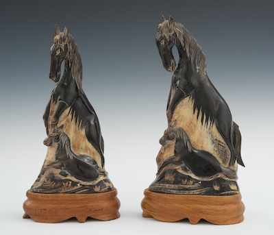 Appraisal: A Pair of Horn Carvings of Horses on Carved Wood