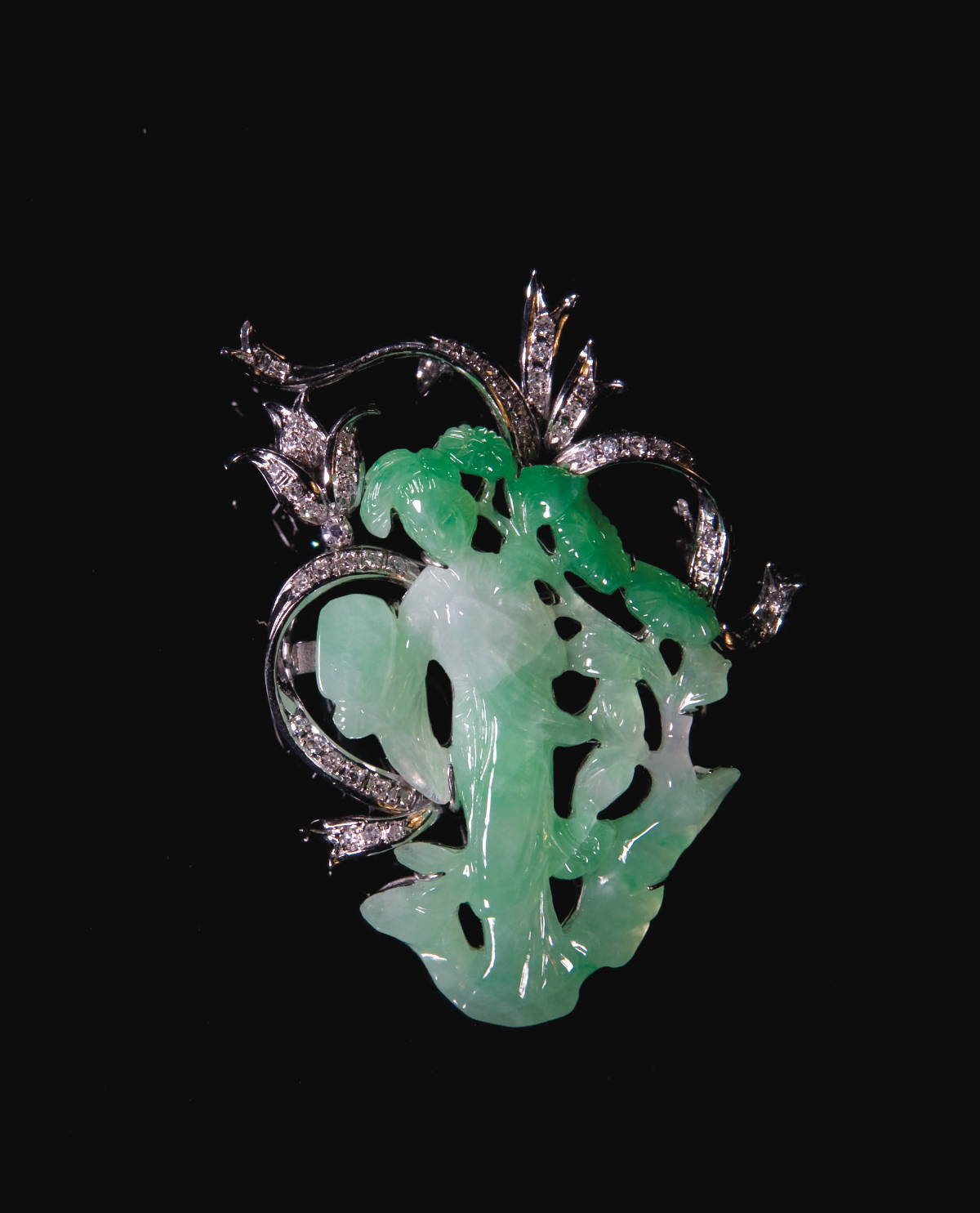 Appraisal: CARVED GREEN JADE AND DIAMOND BROOCH The jade in the