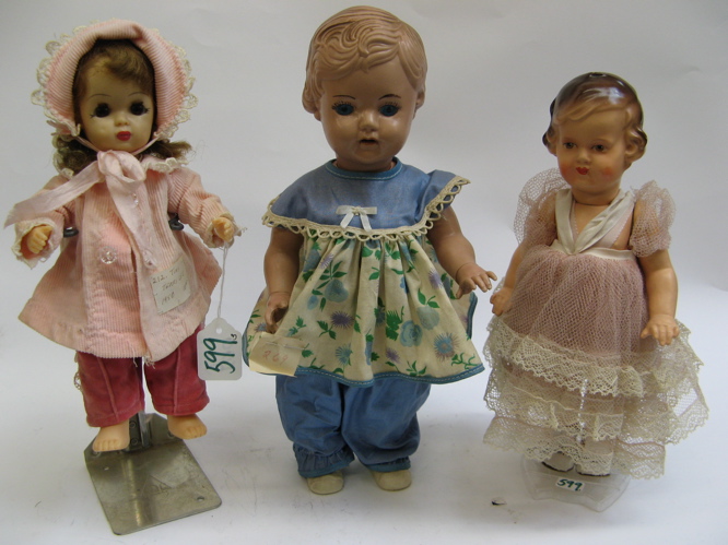 Appraisal: THREE HARD PLASTIC GIRL DOLLS C One is a Tiny