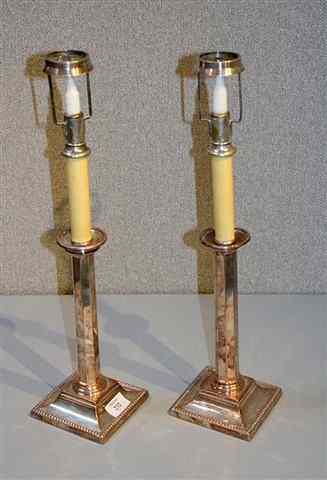 Appraisal: A PAIR OF SILVER PLATE CANDLESTICKS with tapering octagonal columns