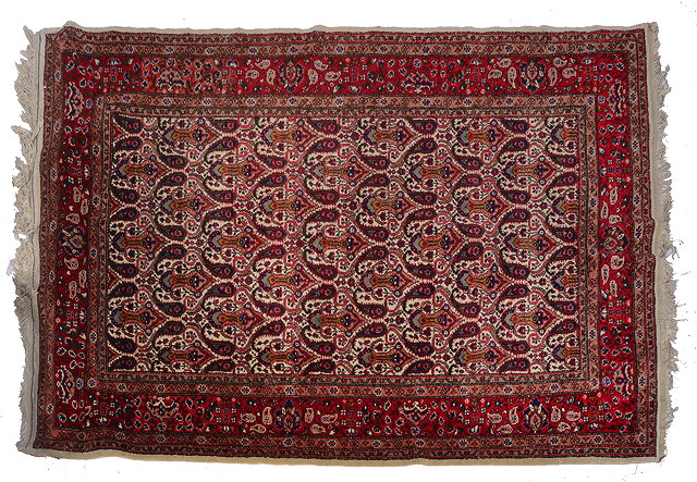 Appraisal: A CREAM GROUND RUG central repeating design within a multiple