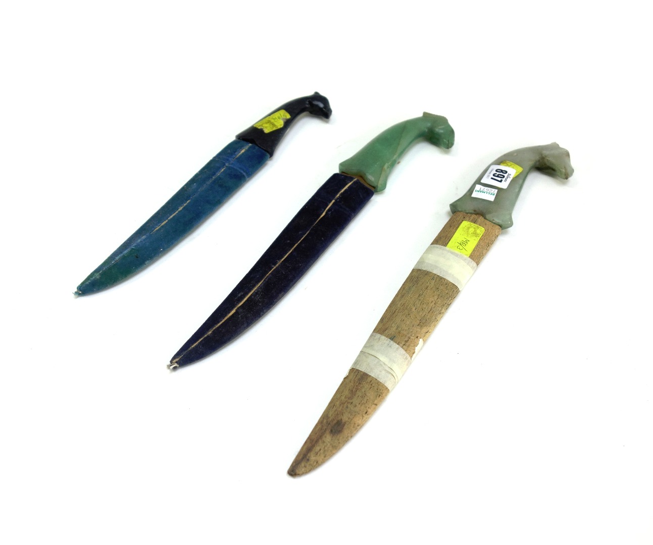 Appraisal: Three stone hilted daggers early th century each with carved