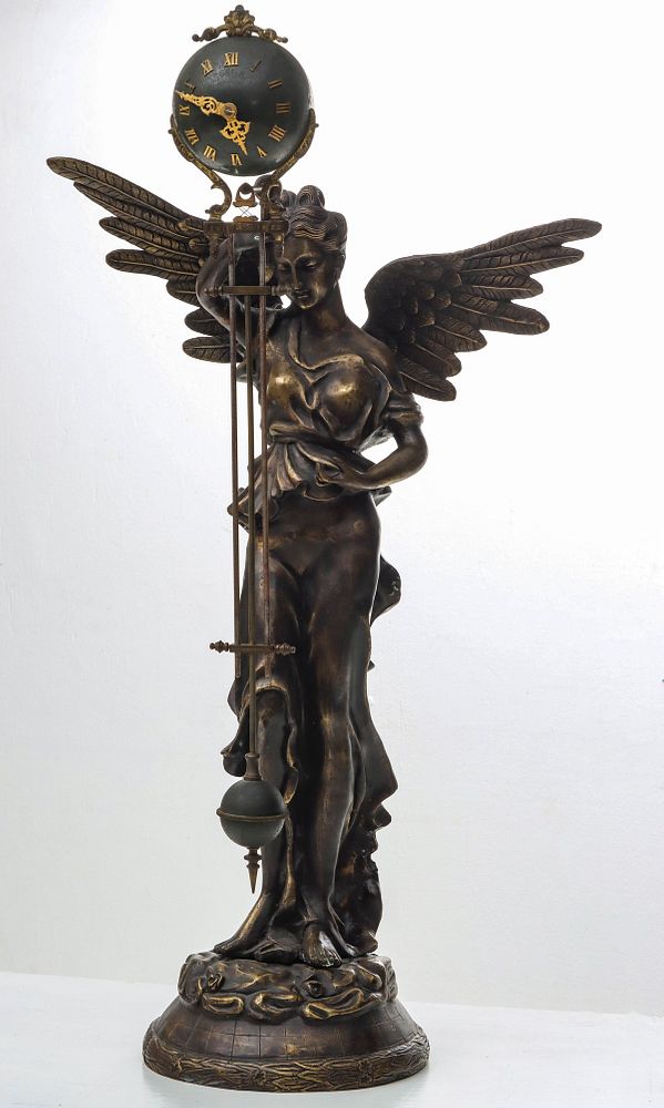 Appraisal: A REPRO BRONZE WINGED FIGURE WITH SEFIA MYSTERY CLOCK The