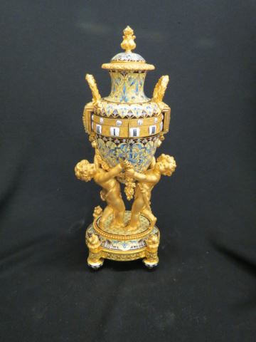 Appraisal: French Enameled Bronze Clock urn shape with cherubs holding it