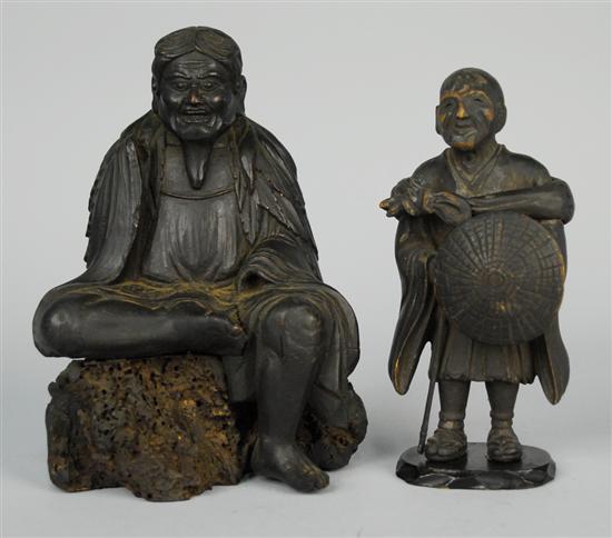 Appraisal: TWO CARVED WOOD FIGURES one a standing warrior the other