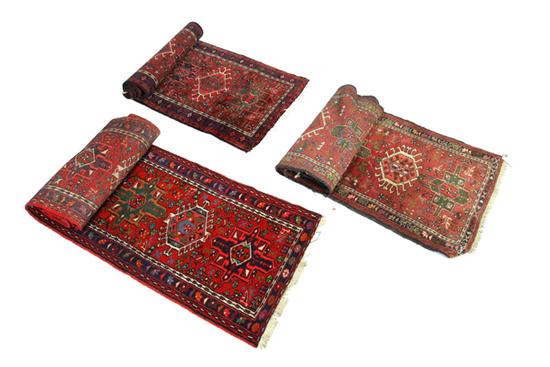 Appraisal: THREE ORIENTAL RUNNERS Twentieth century All with dark red to