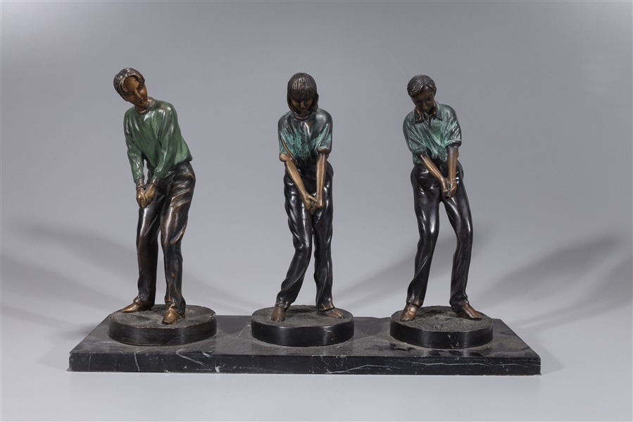 Appraisal: Group of three bronze golfers on marble base some wear