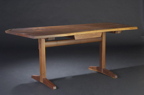 Appraisal: GEORGE NAKASHIMA Walnut single-drawer writing table its top with natural