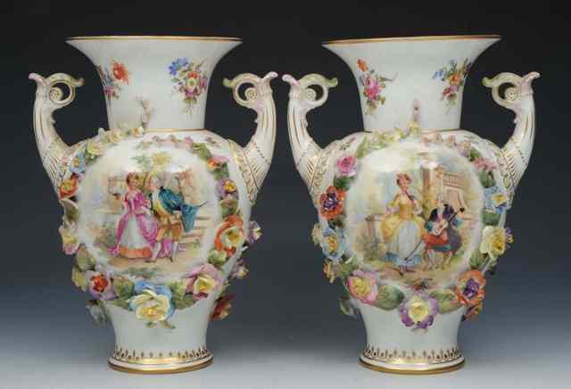 Appraisal: A PAIR OF CONTINENTAL WHITE GROUND PORCELAIN TWO HANDLED VASES