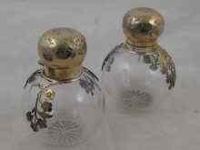 Appraisal: A pair of silver mounted scent bottles with applied floral