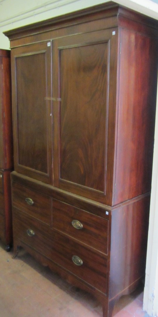 Appraisal: A George III mahogany linen press the pair of panel