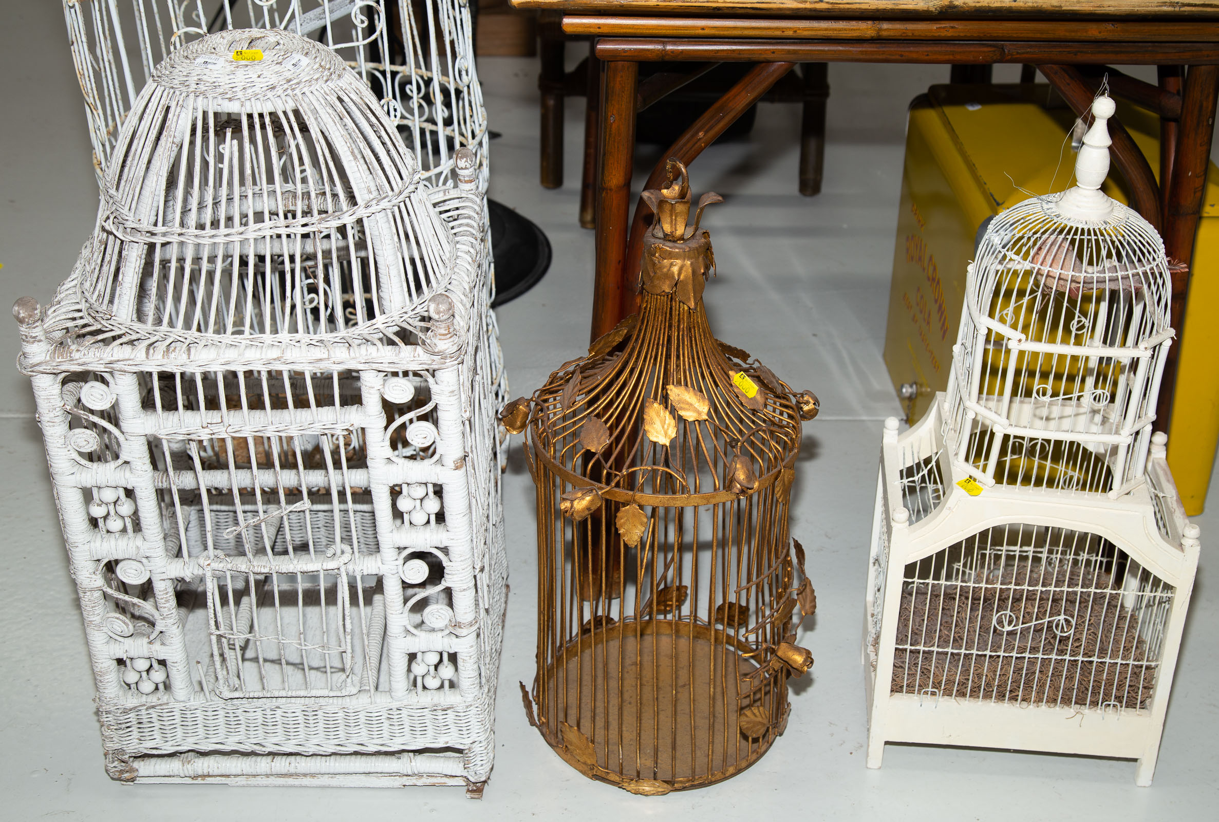 Appraisal: FOUR VINTAGE DECORATIVE BIRD CAGES Including a wicker cage st