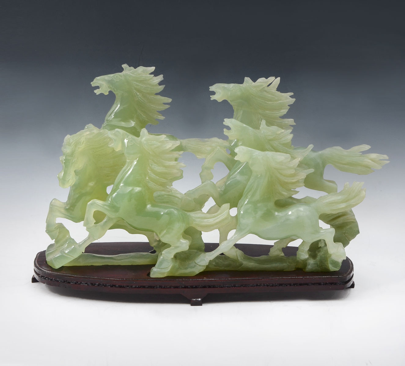 Appraisal: CARVED JADE RUNNING HORSE GROUPING Chinese carved pierced celadon jade