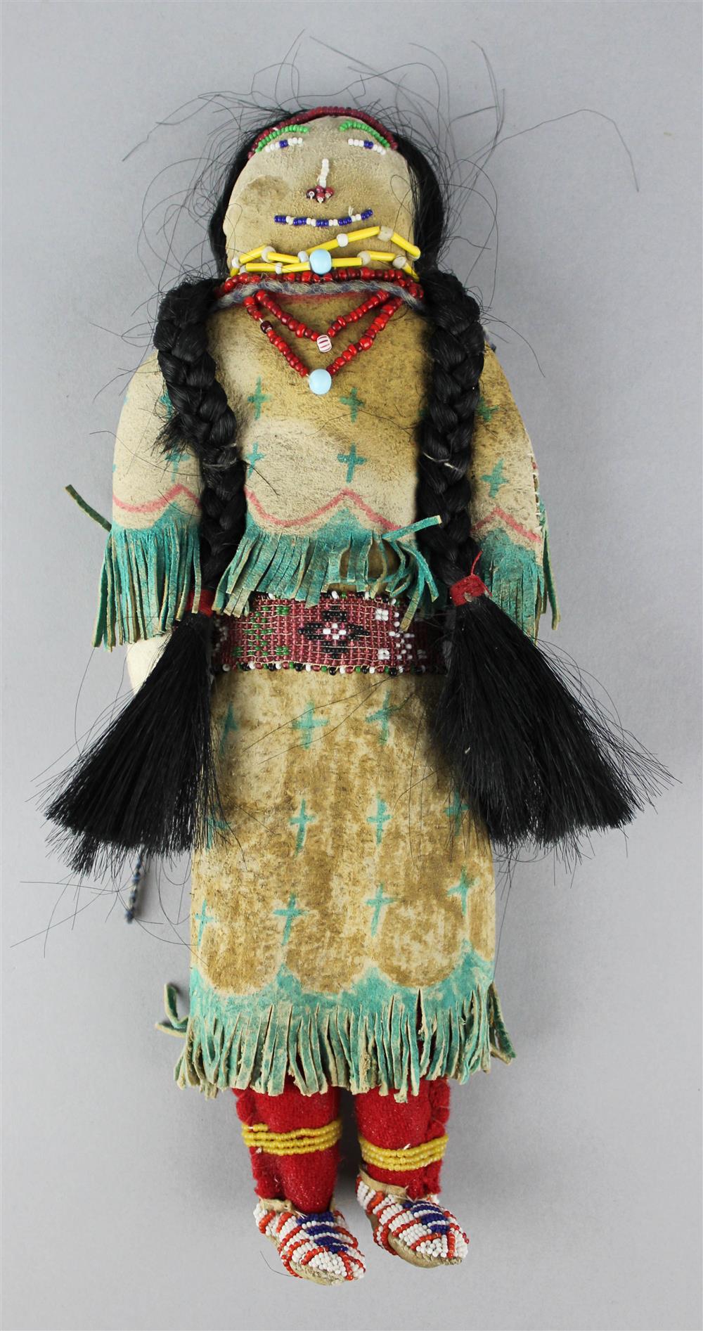 Appraisal: PLAINS POLYCHROMED FRINGED AND BEADED HIDE DOLL Reservation period with