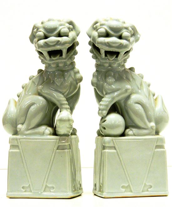 Appraisal: th C pair of Chinese foo dogs pale celadon glaze