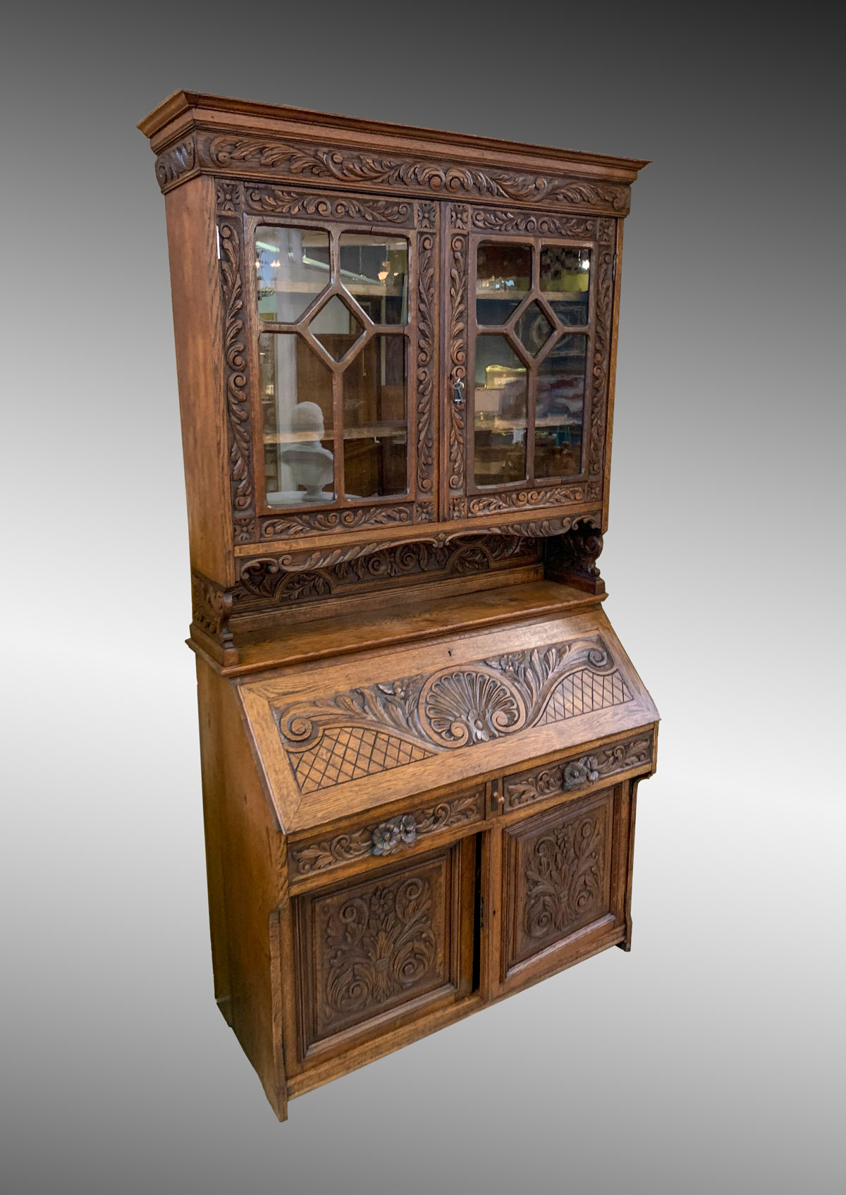 Appraisal: CARVED OAK BOOKCASE DESK Oak bookcase having an overall scrolling