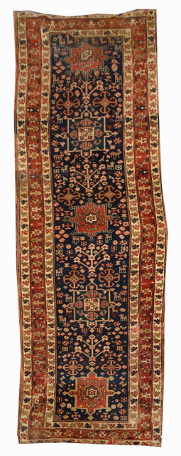 Appraisal: A CAUCASIAN BLUE GROUND RUNNER decorated hooked medallions within a