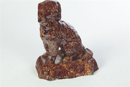 Appraisal: ROCKINGHAM DOG American mid th century Seated spaniel on a