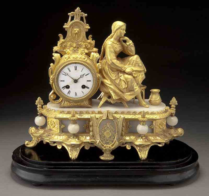 Appraisal: French gilt bronze figural mantle clock the clock face surmounted