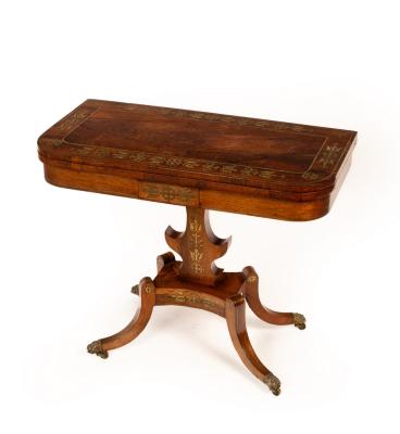 Appraisal: A Regency rosewood and brass inlaid card table the fold