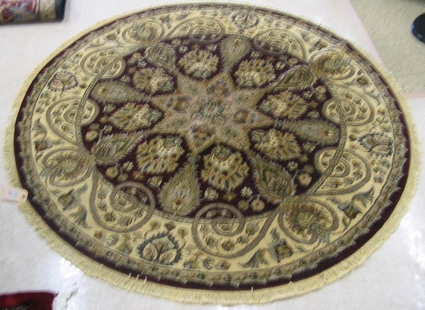 Appraisal: A ROUND ORIENTAL ACCENT RUG Indo-Persian overall floral decoration on