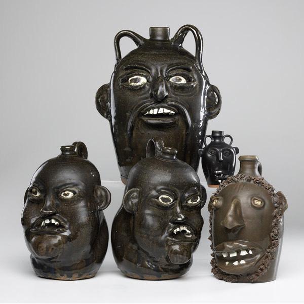 Appraisal: HEWELL ETC Five Folk Art face jugs two by Matthew