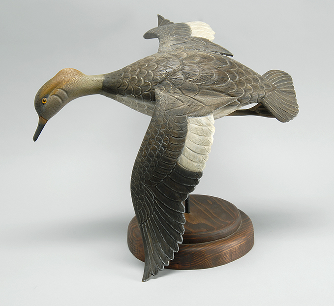 Appraisal: LIFE-SIZED CARVING OF A HOODED MERGANSER HEN Maker unknown In