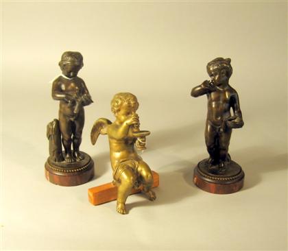 Appraisal: Three Continental bronze figures of putti The first putto holding