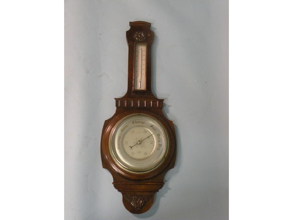 Appraisal: A 's carved oak aneroid barometer by Smiths cm high