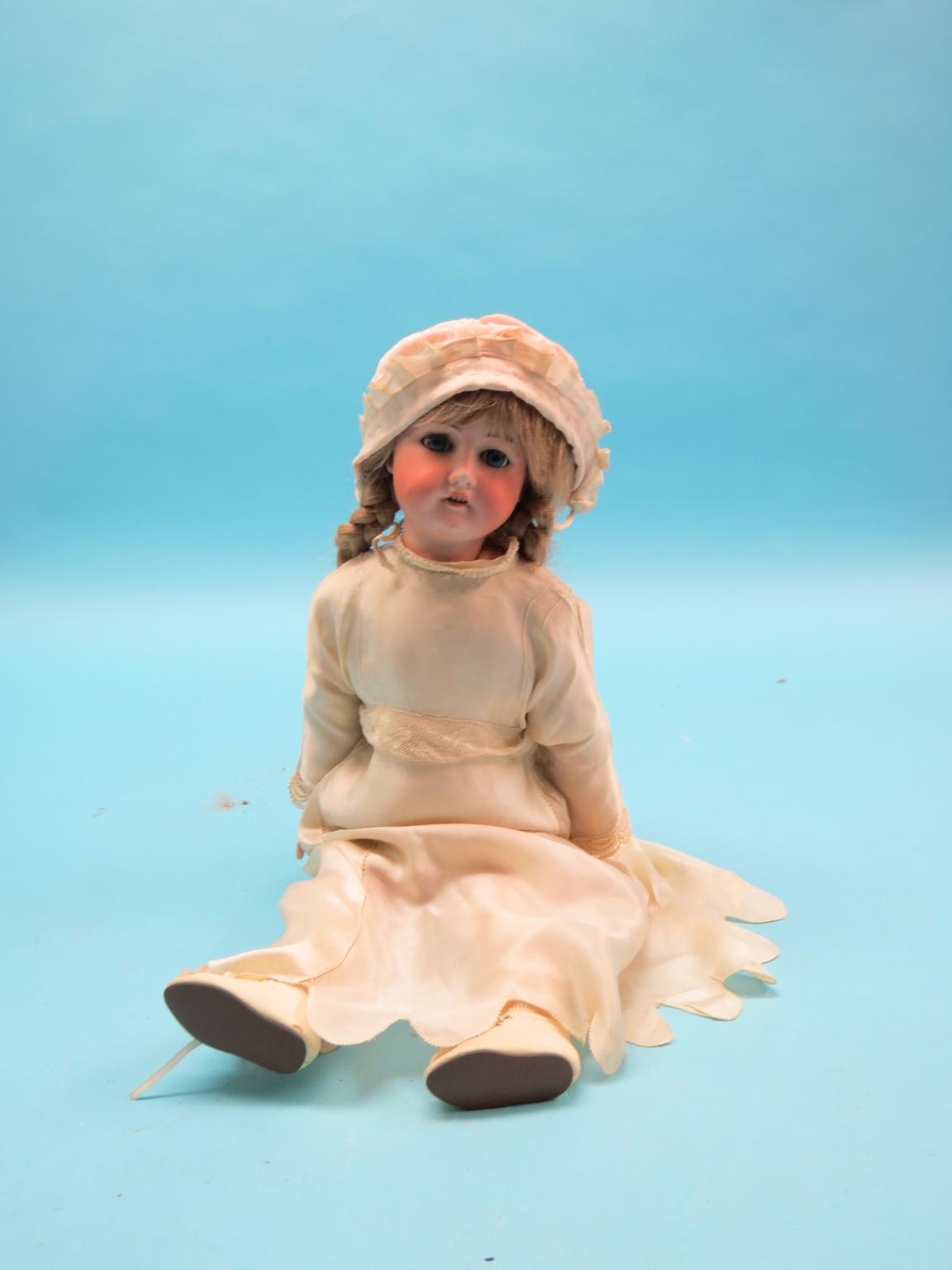 Appraisal: A German bisque doll with sleeping eyes clothed in -