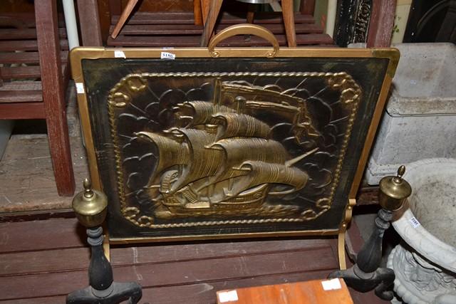 Appraisal: A METAL EMBOSSED FIRESCREEN AND A PAIR OF ANDIRONS