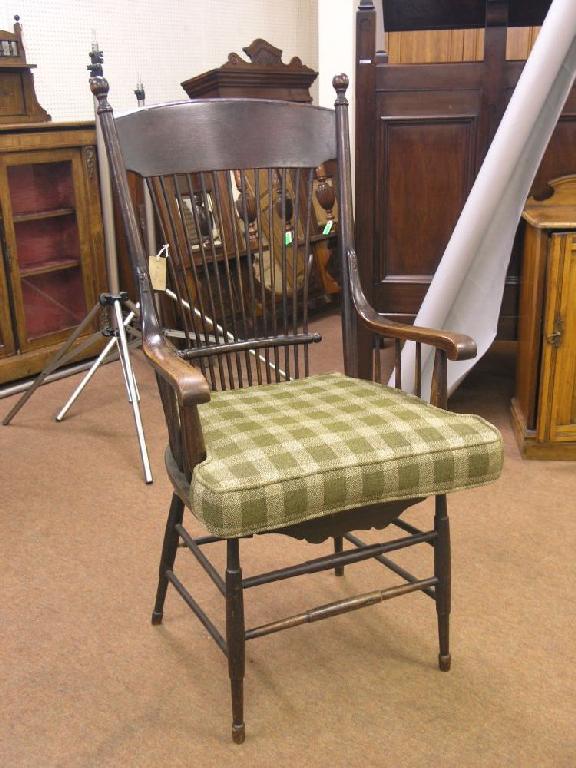 Appraisal: An Arts and Crafts oak elbow chair with spindle back