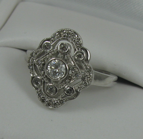 Appraisal: DIAMOND AND FOURTEEN KARAT WHITE GOLD RING the top of