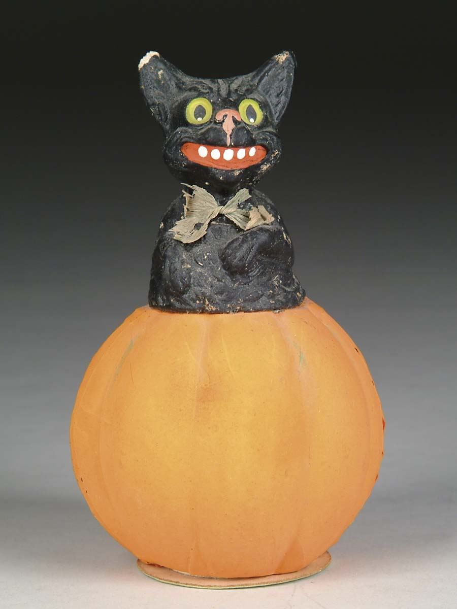 Appraisal: PUMPKIN WITH BLACK CAT CONTAINER Pressed paper pumpkin candy container