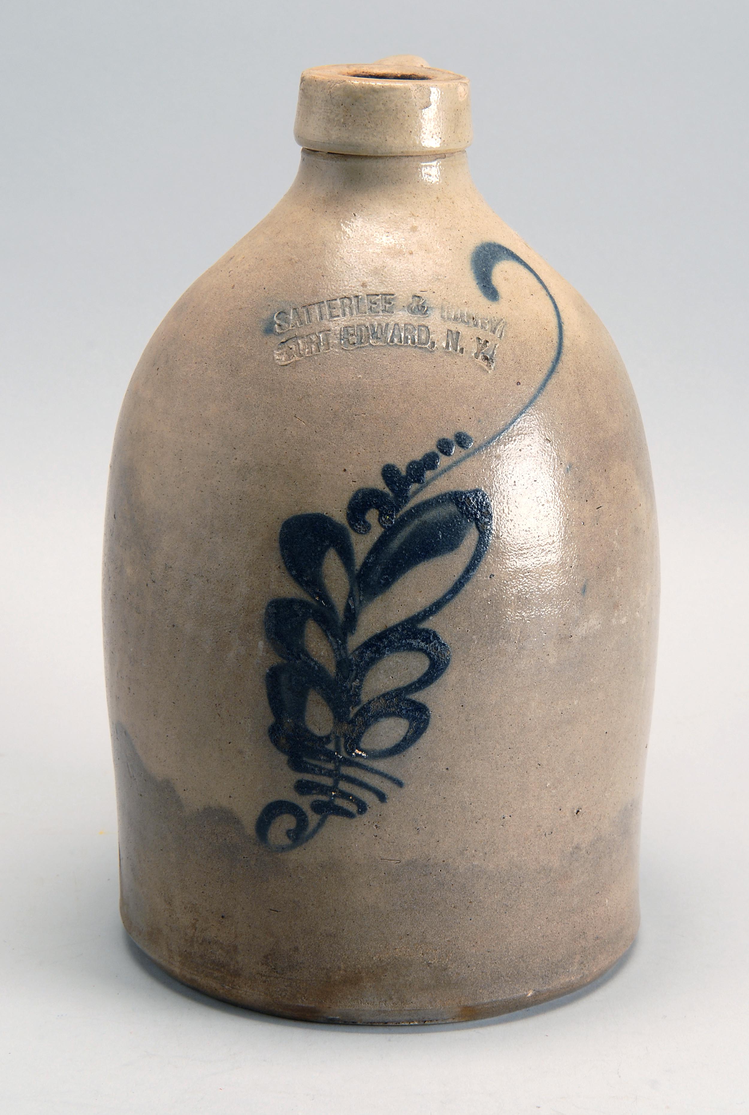 Appraisal: TH CENTURY AMERICAN STONEWARE JUG with cobalt blue foliate decoration