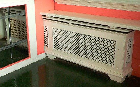 Appraisal: A double pierced cast radiator surround with pierced ends and