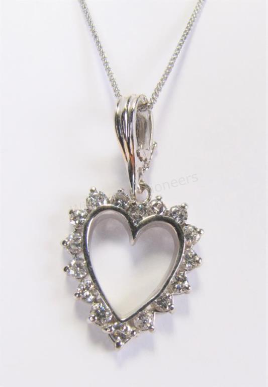 Appraisal: A K white gold open heart pendant containing sixteen round