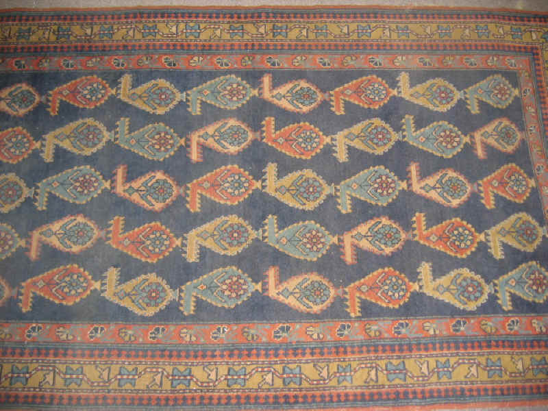 Appraisal: CAUCASIAN DESIGN THROW RUG The indigo field shows an all